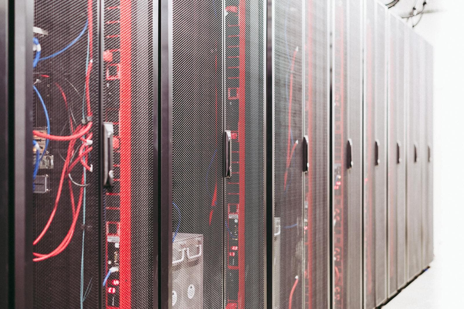 Rows of data-centre server racks with bundled cabling.