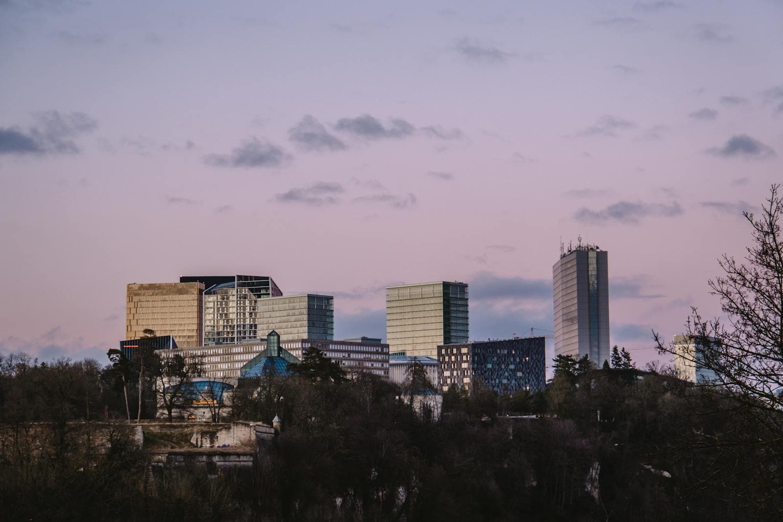 Kirchberg financial-district towers in Luxembourg City at sunset.