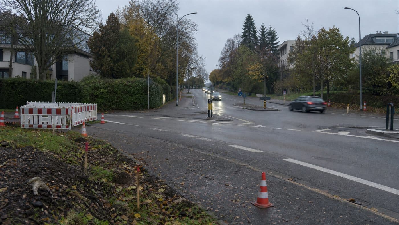 A Luxembourg suburban road near a residential area, photographed in a restrained editorial style.